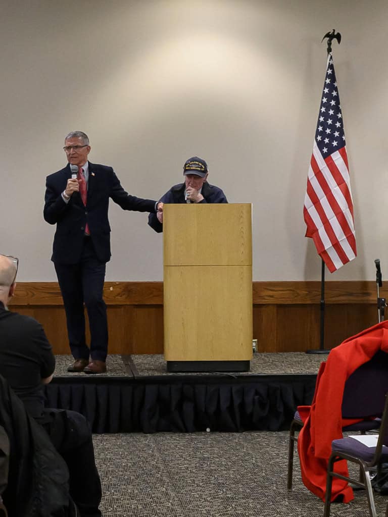 Bernadette Smith speaking at a campaign event with a supporter.
